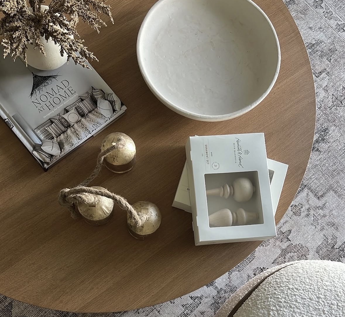 Styled coffee table with ceramic bowl and design book