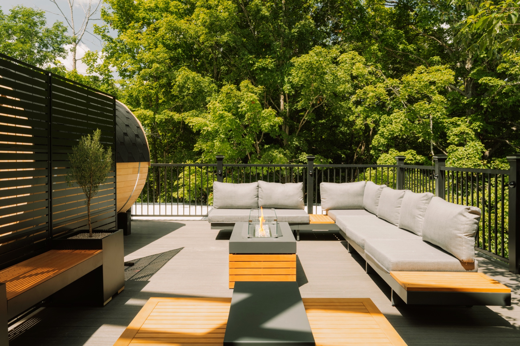 Finished rooftop terrace with modern seating and a fire table, fully styled and delivered